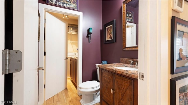 bathroom with vanity, hardwood / wood-style floors, and toilet