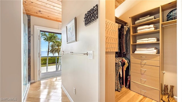 spacious closet featuring lofted ceiling and light hardwood / wood-style floors