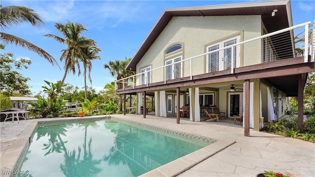 rear view of house featuring ceiling fan, a balcony, and a patio area