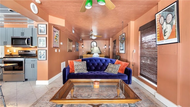 tiled living room with ceiling fan