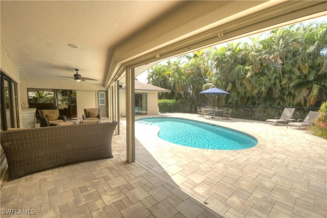 view of swimming pool with ceiling fan and a patio area