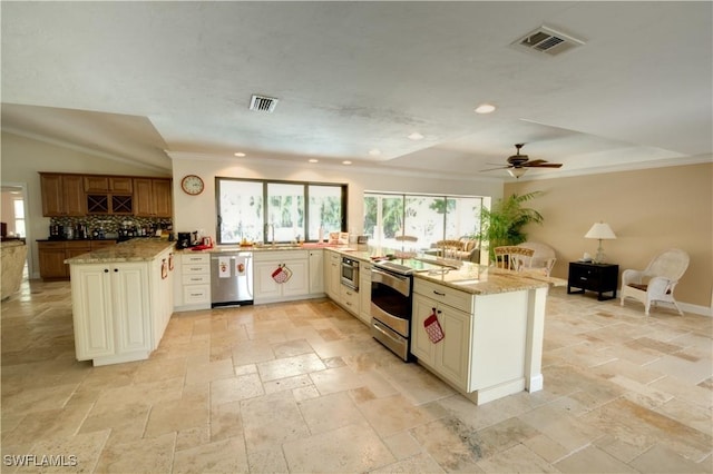 kitchen with stainless steel appliances, decorative backsplash, light stone counters, and kitchen peninsula