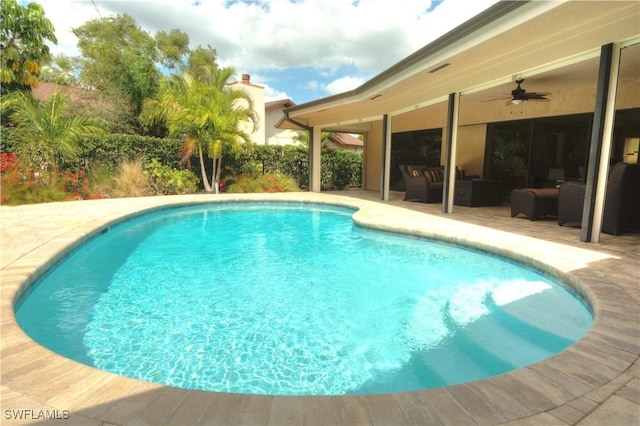 view of swimming pool featuring outdoor lounge area, ceiling fan, and a patio area