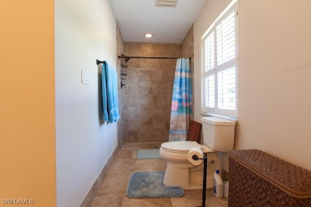 bathroom featuring tile patterned flooring, a shower with curtain, and toilet