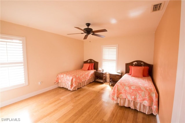 bedroom with hardwood / wood-style floors and ceiling fan