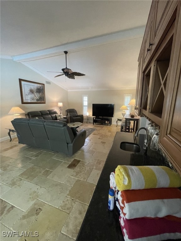 living room with crown molding, sink, vaulted ceiling with beams, and ceiling fan