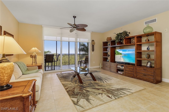 living room featuring ceiling fan and light tile patterned flooring