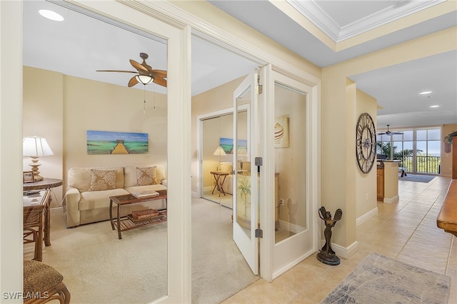 hallway featuring ornamental molding, light tile patterned floors, and french doors