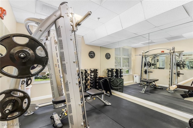 gym with a paneled ceiling