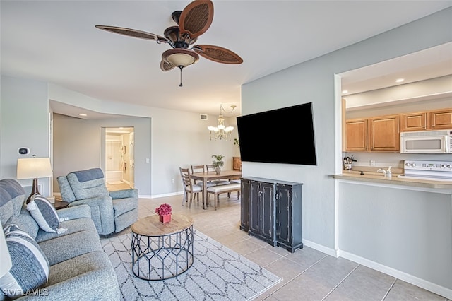 living room with light tile patterned flooring and ceiling fan with notable chandelier