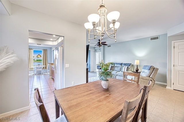 tiled dining space featuring ceiling fan with notable chandelier