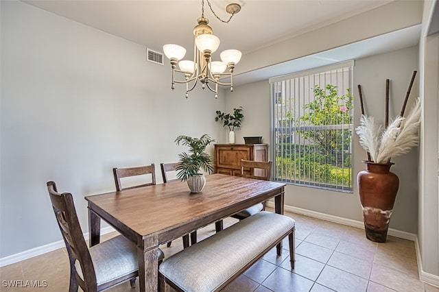 tiled dining space with a chandelier