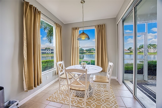 tiled dining area featuring a water view