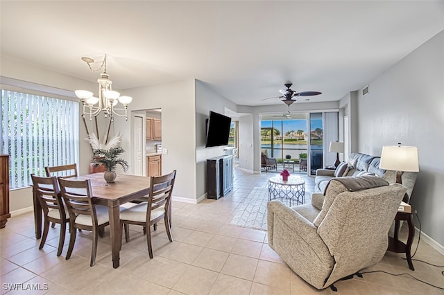 dining room featuring ceiling fan with notable chandelier and light tile patterned floors