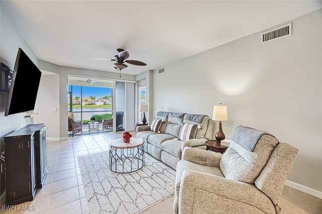 tiled living room with ceiling fan