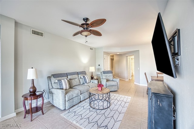 tiled living room with ceiling fan