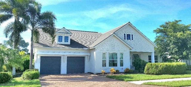 view of front facade featuring a garage and decorative driveway