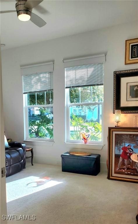 sitting room featuring carpet floors and a ceiling fan