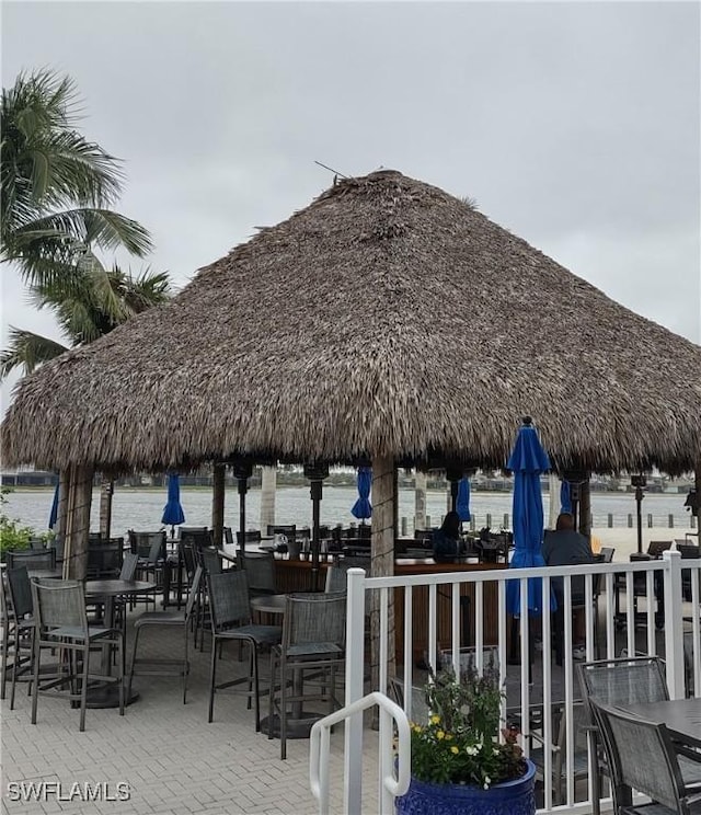 view of community with outdoor dining area, a patio area, and a gazebo