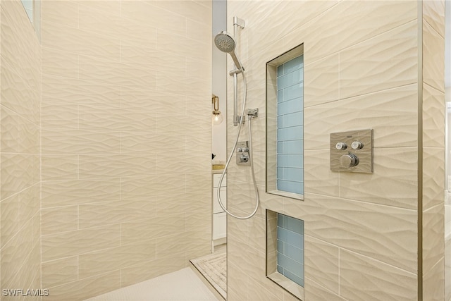 bathroom with a tile shower