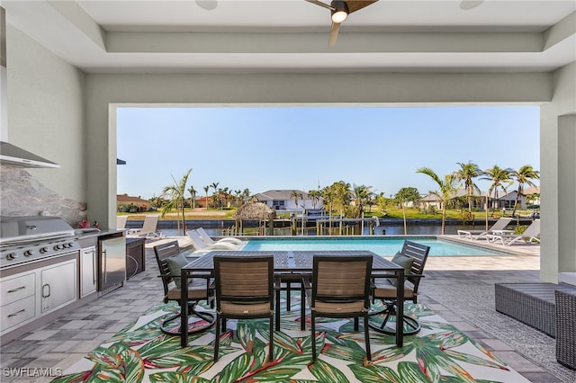 view of patio featuring exterior kitchen, a grill, and ceiling fan