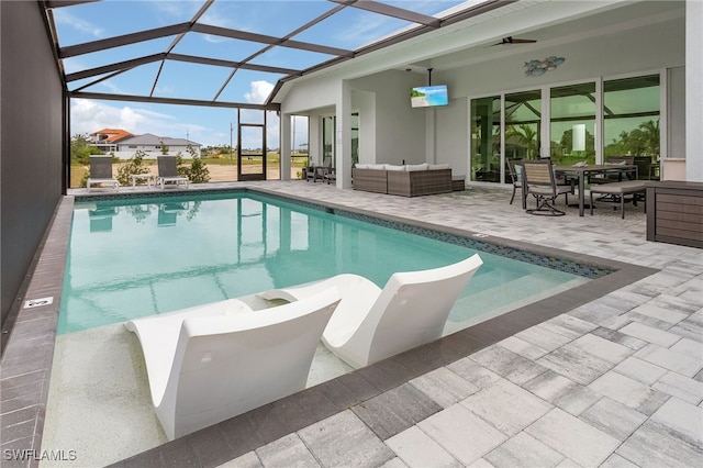 view of pool with ceiling fan, an outdoor hangout area, a patio, and a lanai