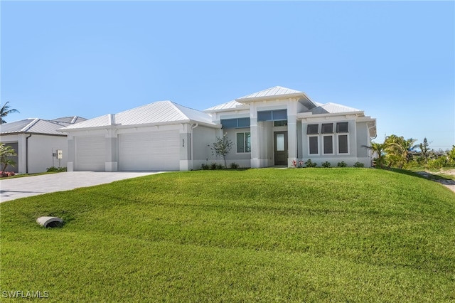 view of front of property featuring a garage and a front lawn