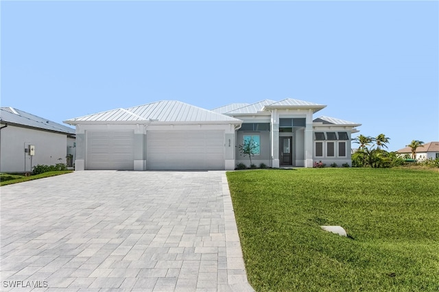 view of front of home with a garage and a front yard