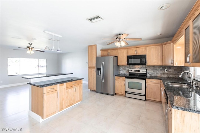 kitchen featuring appliances with stainless steel finishes, sink, ceiling fan, and decorative backsplash