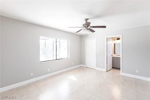 unfurnished bedroom featuring ceiling fan, connected bathroom, and a closet