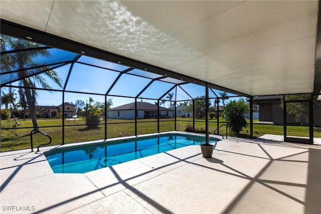 view of swimming pool with a lanai, a lawn, and a patio area