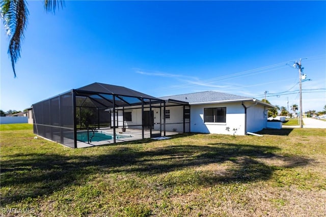 back of house featuring a yard, a lanai, and a patio