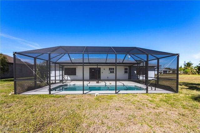 view of pool with a patio, glass enclosure, and a lawn