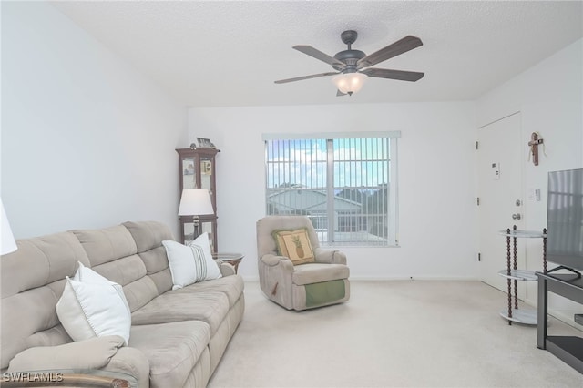 carpeted living room with ceiling fan and a textured ceiling