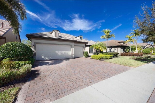 7045 Live Oak Dr, Naples, FL 34114 - ranch-style home featuring driveway, a garage, stucco siding, and a front lawn