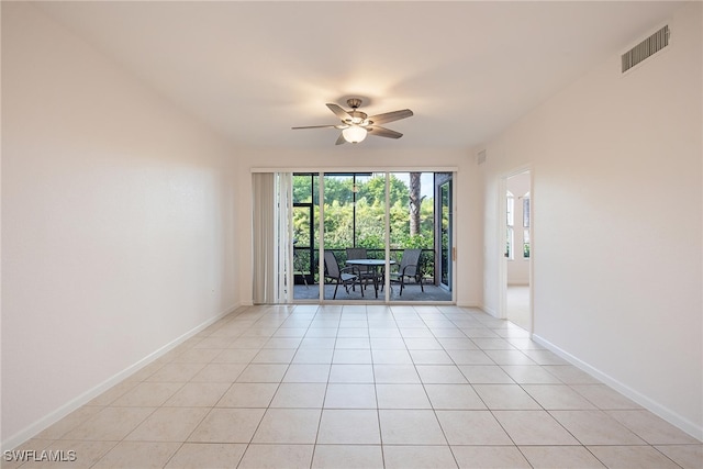 tiled spare room with ceiling fan