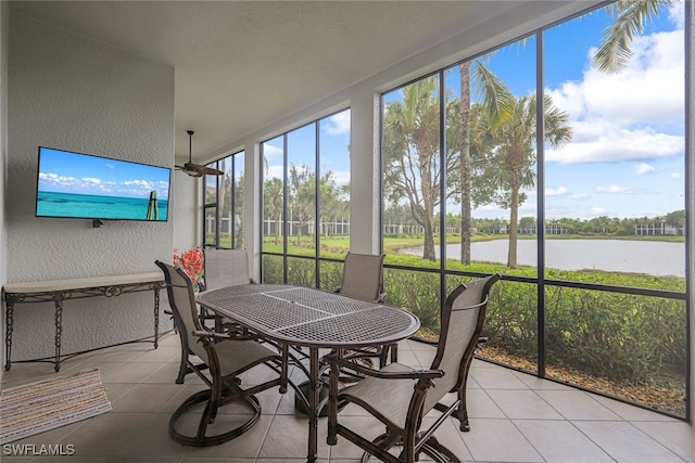 sunroom / solarium featuring a water view, ceiling fan, and plenty of natural light