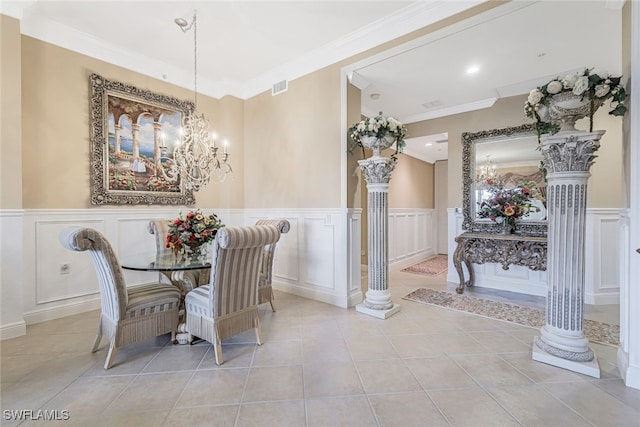 dining room featuring light tile patterned floors, a chandelier, and ornate columns