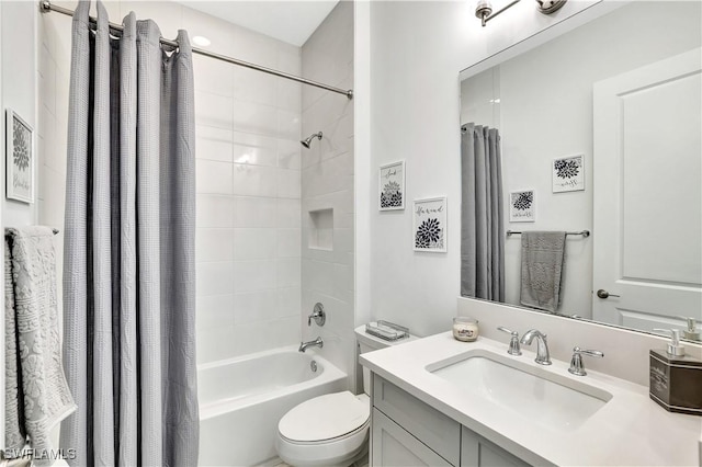 full bathroom featuring vanity, shower / bath combination with curtain, and toilet