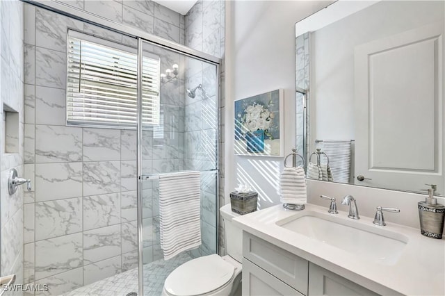 bathroom with vanity, an enclosed shower, and toilet