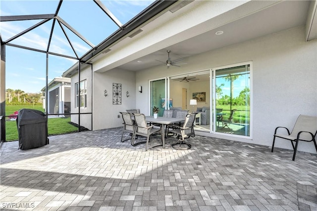 view of patio featuring a lanai and ceiling fan