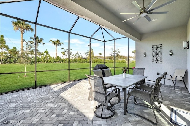 view of patio / terrace featuring ceiling fan and glass enclosure