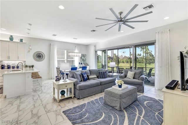 living room featuring sink and ceiling fan