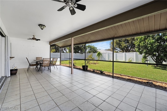 unfurnished sunroom with ceiling fan