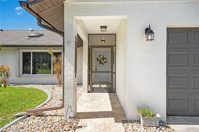 doorway to property with a garage