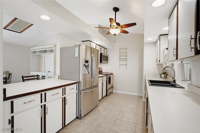 kitchen featuring vaulted ceiling, white cabinets, and appliances with stainless steel finishes