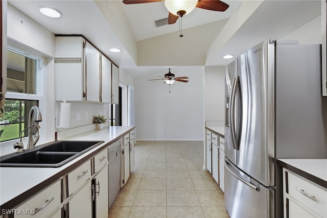 kitchen featuring sink, ceiling fan, appliances with stainless steel finishes, white cabinets, and light tile patterned flooring