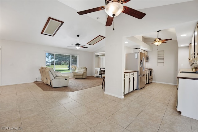 unfurnished living room featuring vaulted ceiling, sink, and light tile patterned floors