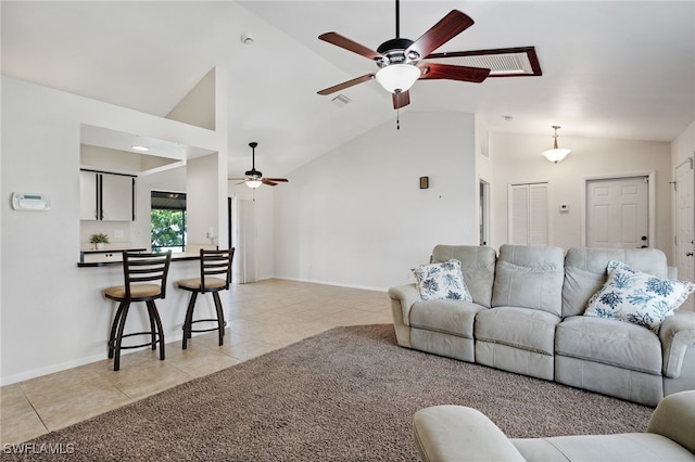 tiled living room with high vaulted ceiling and ceiling fan