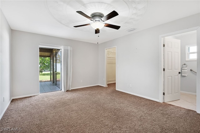 empty room featuring light carpet and ceiling fan